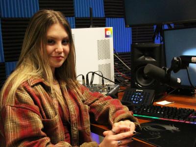 Students sits in the recording studio
