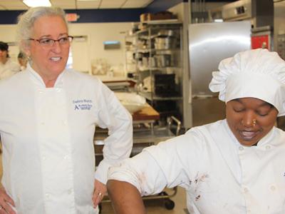 Deb Burch works with a baking student