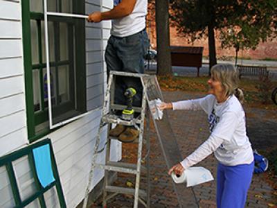 CSCA Day- Alfred State student Jake Paquette and staff member Kathy Bayus volunteer at Alfred Box of Books Library