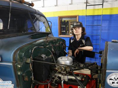 student working on a tow truck