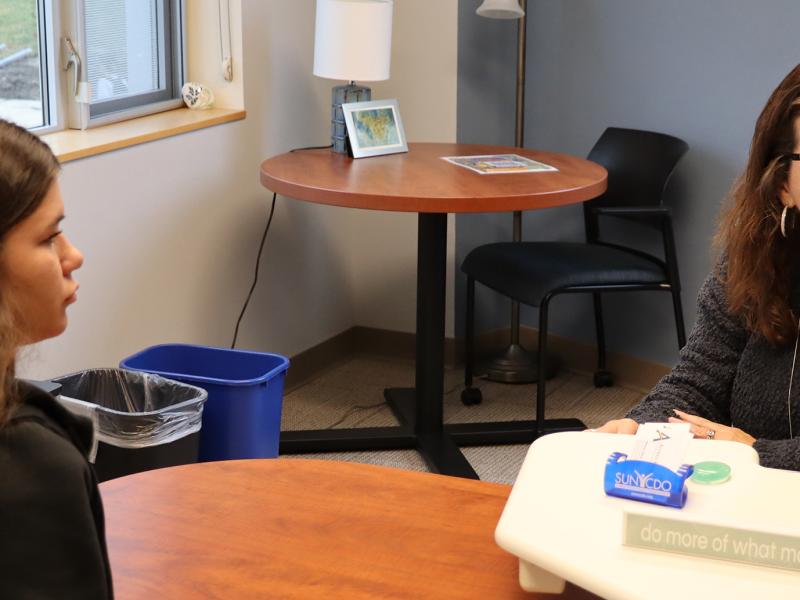 student sits with career development employee