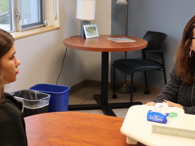student sits with career development employee