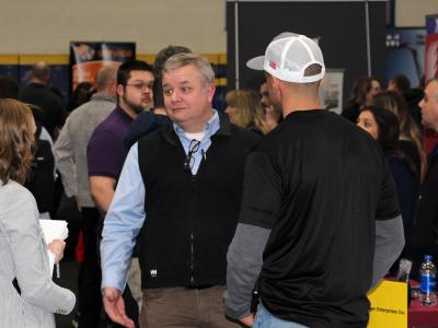 Employers talk to an Alfred State student about career opportunities at a past career fair.