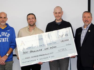 Alfred State faculty accept a check for $10,000