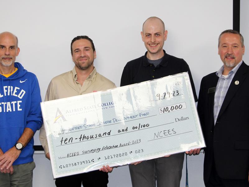 Alfred State faculty accept a check for $10,000