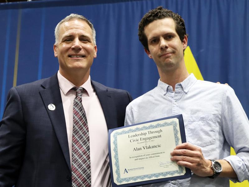 Alan Vlakancic accepts award from Dr. Mauro