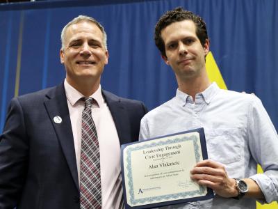 Alan Vlakancic accepts award from Dr. Mauro