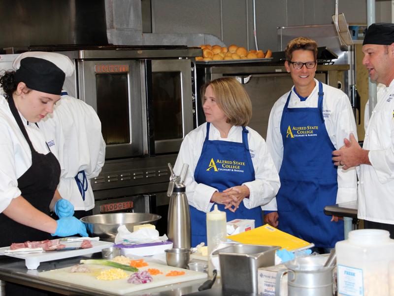 Students work with faculty in the kitchen