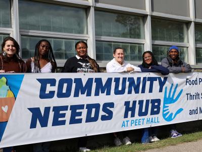 Staff of the Community Needs Hub stands outside their new space