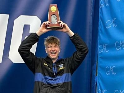 Conor Compton stands on the award stand after capturing 7th place at the NCAA Division III National Championship for performance on the 3m diving board.