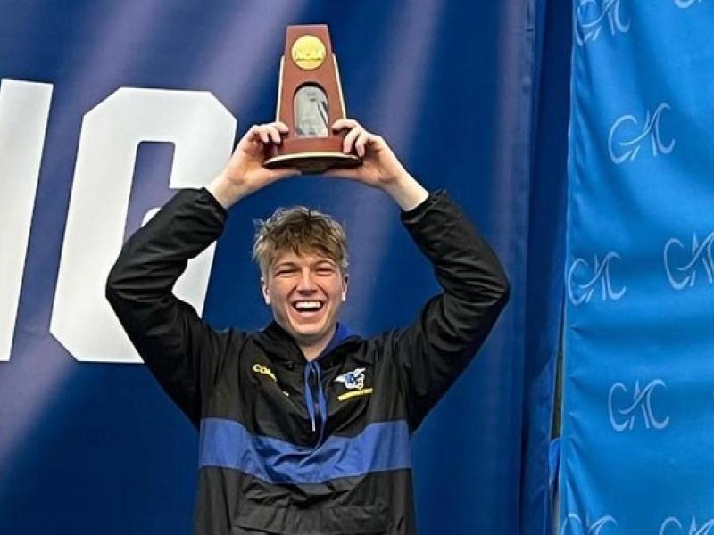 Conor Compton stands on the award stand after capturing 7th place at the NCAA Division III National Championship for performance on the 3m diving board.