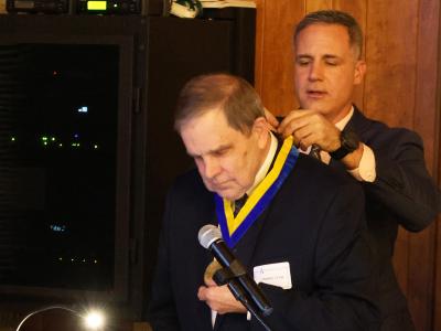 Dr. Mauro put the President's Medallion on Charles Craig