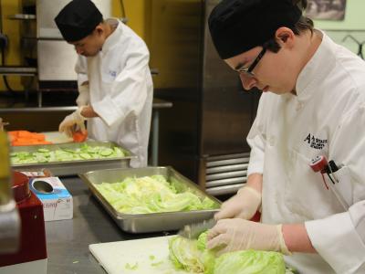 Culinary arts students prepare salads