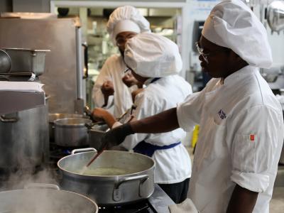 Students working near a stove