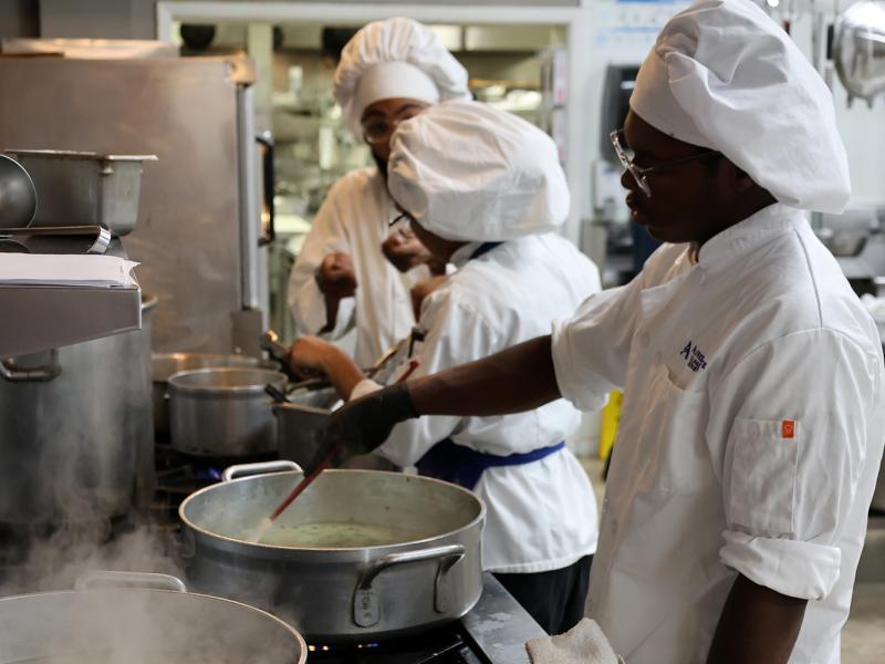 Students working near a stove