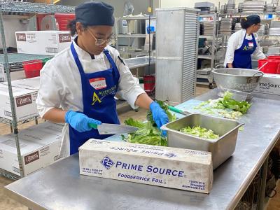 An Alfred State student prepares a meal in a kitchen