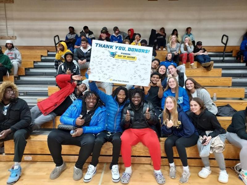 ASC students display a Thank You Donors sign.