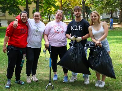students posing at a community clean-up event.