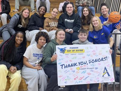 students with a thank you card