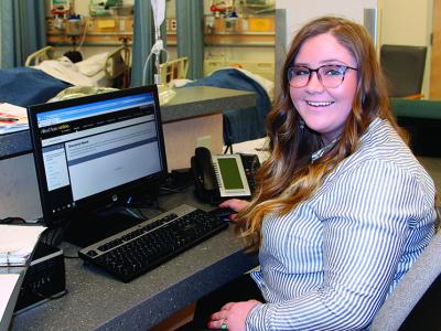 student sitting at a computer in a healthcare facility