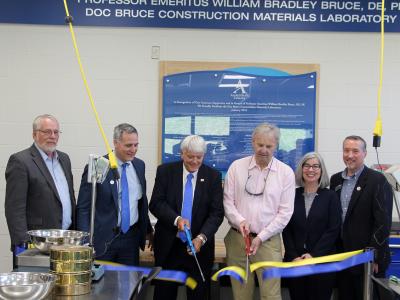 1977 Alfred State graduates Jimmy Smith and Gary Hill cut the ribbon for the Doc Bruce Construction Materials Laboratory.