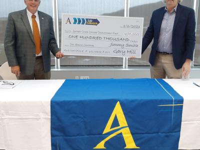 two men holding a check