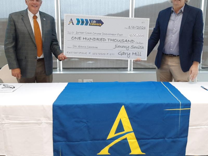 two men holding a check