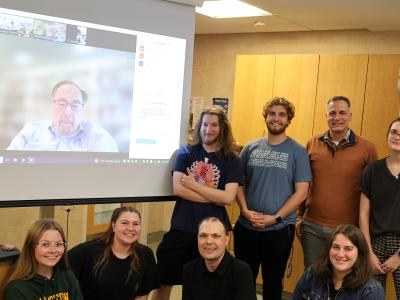 Students pose with Dr. Baltimore