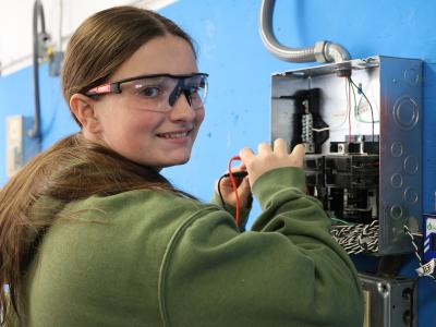 student works in an electric panel