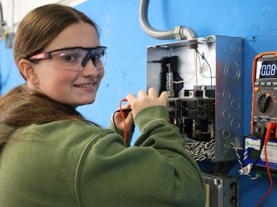 student works in an electric panel