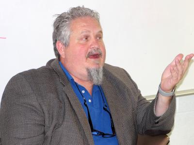 Evan Enke speaks to his students in the classroom.