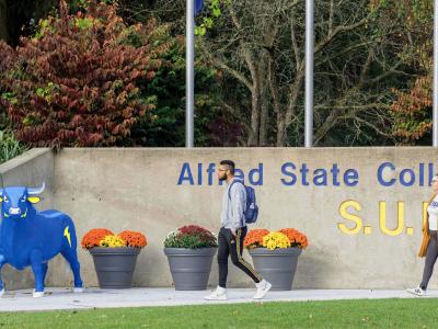 students walk past main entrance of Alfred State