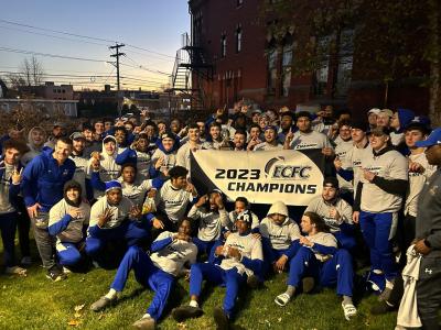ASC football team with their championship banner