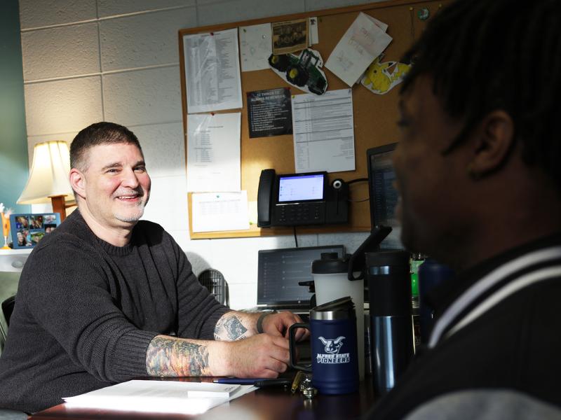 Students speaks with financial aid counselor