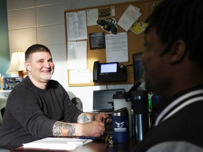 Students speaks with financial aid counselor