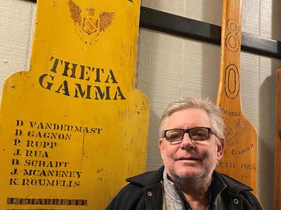 David Gagnon stands next to his pledge class paddle.