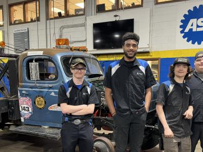 Alfred State students in front of a 1953 Dodge Power Wagon tow truck