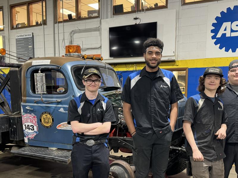 Alfred State students in front of a 1953 Dodge Power Wagon tow truck