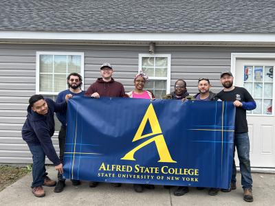 ASC students outside the house they worked on with Habitat for Humanity
