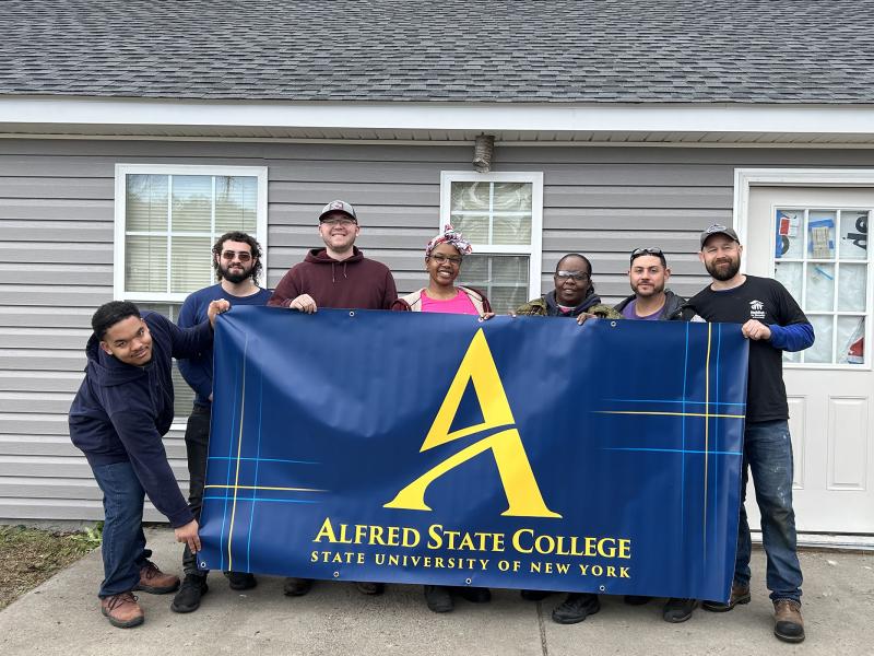 ASC students outside the house they worked on with Habitat for Humanity