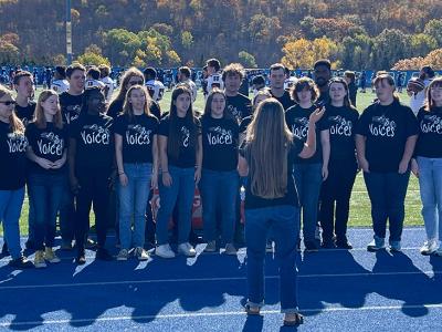 Alfred Voices performs the National Anthem at the football game.