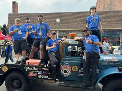 students pose with the 1953 Dodge Power Wagon driven during The Great Race