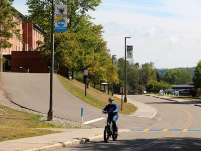 A student tests out one of the new electric bikes.