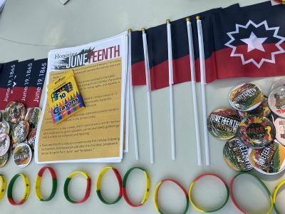The Cultural Life Center provided information, buttons, and flags about Juneteenth at the Alfred Farmers Market