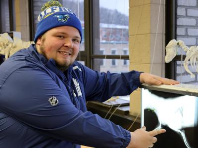 smiling student as he looks at x-rays
