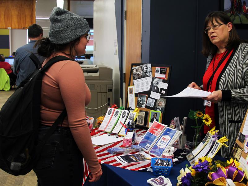 A student speaks with a League of Women Voters representative