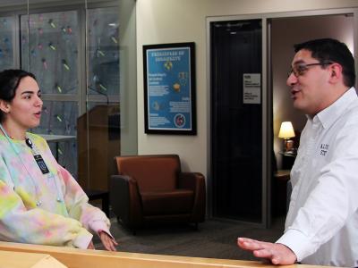 lfred State Chief Diversity Officer and Title IX Coordinator Matt Ryan talks with a student outside of his office in the Student Leadership Center.