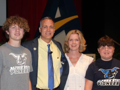 Dr. Steven Mauro poses with his wife Melissa and his sons Owen and Quinn prior to the start of his State of Alfred State address.