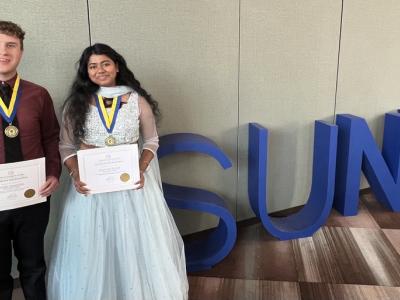 Soumya Konar and Noah Bastedo pose near the SUNY sign after receiving the Chancellor’s Award for Student Excellence in a ceremony held in Albany.