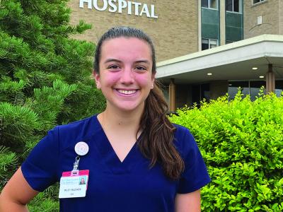 Riley Mucher stands outside a hospital